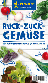 Radishes, basil, leek, lettuce, and spinach auf weißem Holzvorgrund.