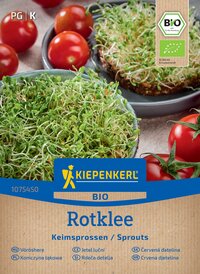 Sprossen und Tomaten auf einer Packung mit Kiepenkerl Bio Rotklee Samen, im Hintergrund Tomaten und Brotscheiben mit Sprossen.